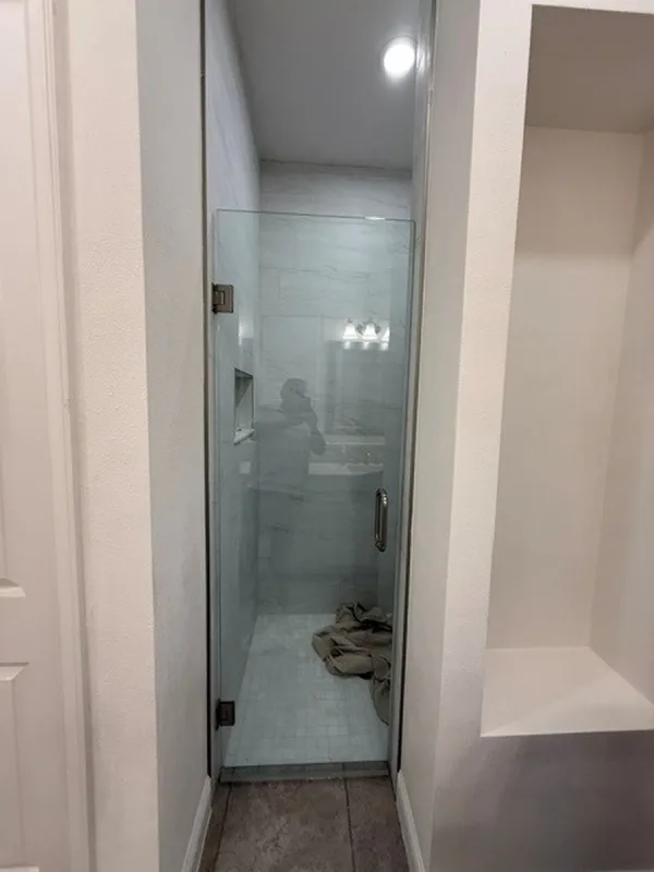 Glass shower door and tile walls in a finished Lake Nona bathroom renovation