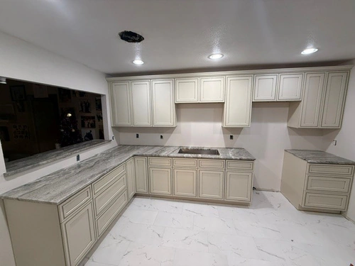 New cream raised panel cabinets and stone counters installed in an Orlando kitchen before the appliances went in