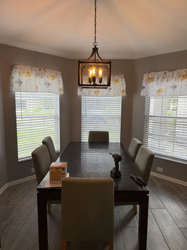 Finished dining room with a flat painted ceiling, grey walls and a lantern pendant over the table