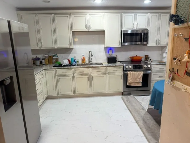 Orlando kitchen after renovation, with new shaker cabinets, counters and tile flooring